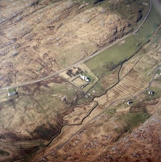 Oblique aerial view centred on the manse with the remains of the township adjacent, taken from the NE.