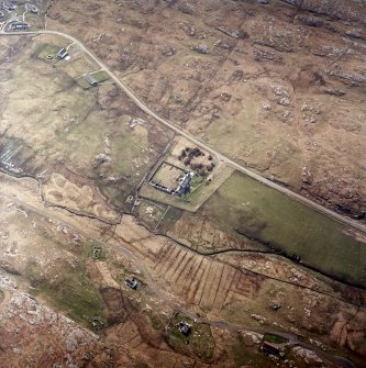 Oblique aerial view centred on the manse with the remains of the township adjacent, taken from the N.