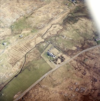 Oblique aerial view centred on the manse with the remains of the township adjacent, taken from the WSW.