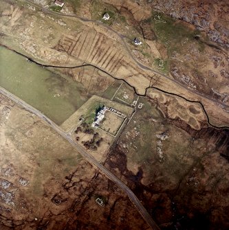 Oblique aerial view centred on the manse with the remains of the township adjacent, taken from the SSE.