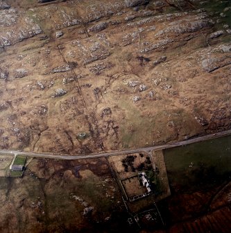 Oblique aerial view centred on the manse with the remains of the township adjacent, taken from the NE.