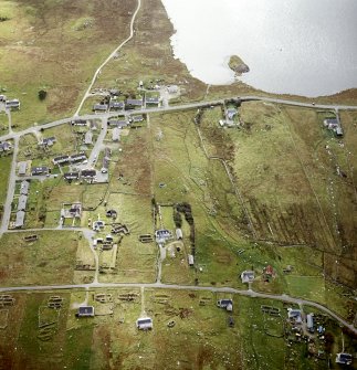 Oblique aerial view centred on remains of the horizontal mills with the remains of the corn-drying kiln, broch and possible crannog adjacent, taken from the N.
