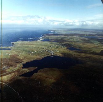 General oblique aerial view looking across Bragar up the west coast of Lewis towards Arnol, taken from the SW.