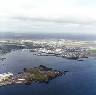 General oblique aerial view looking across Arnish Point towards the town, taken from the SSE.