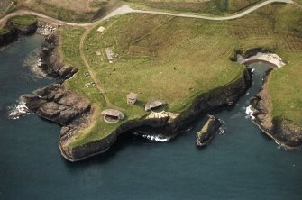 Oblique aerial view centred on the remains of the coast battery, taken from the ESE.
