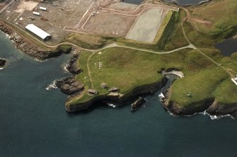 Oblique aerial view centred on the remains of the coast battery, taken from the E.