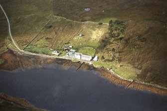 Oblique aerial view centred on the lodge and kennels with the remains of lazy beds adjacent, taken from the NE.