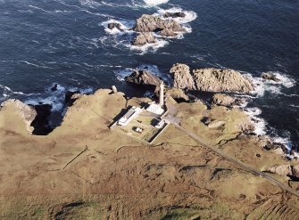 Oblique aerial view centred on the lighthouse with the enclosure adjacent, taken from the S.