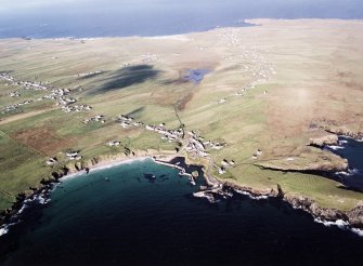 General oblique aerial view looking across the harbour, crofting township and lazy beds towards the townships, taken from the ESE.