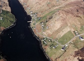 Oblique aerial view centred on the township and the remains of the buildings, taken from the SE.