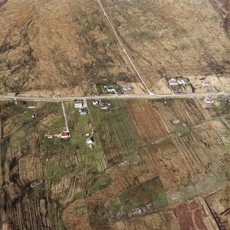 Oblique aerial view centred on the township and the remains of the buildings, taken from the SSW.