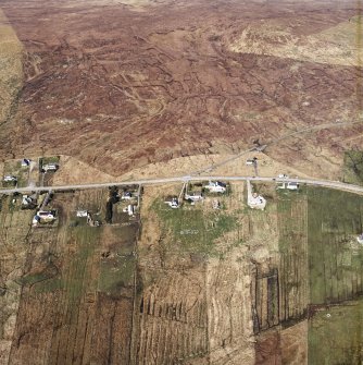 Oblique aerial view centred on the township, the remains of the buildings and church, taken from the S.