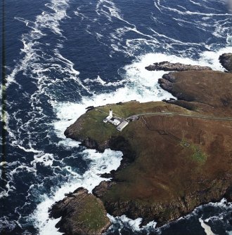 Oblique aerial view centred on Tiumpan Head Lighthouse, Lewis, and keepers cottages, taken from the NW.
