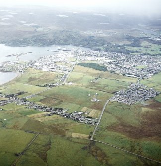 Oblique aerial view centred on the township with the town adjacent, taken from the ENE.
