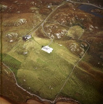 Oblique aerial view centred on the shooting lodge and lazy beds with the cottage and kennels adjacent, taken from the SW.