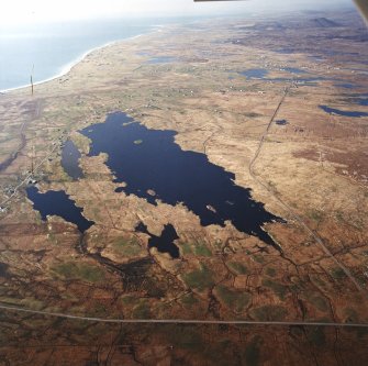 General oblique aerial view looking across the remains of the township towards Dalabrog and Askernish in the distance, taken from the SSE.