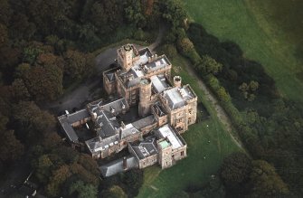 Oblique aerial view centred on the country house and college, taken from the W.