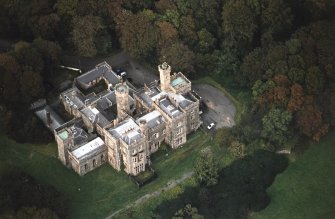 Oblique aerial view centred on the country house and college, taken from the SSE.