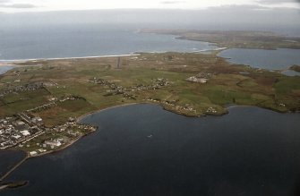 General oblique aerial view looking across the township towards the airport, taken from the SW.