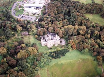 Oblique aerial view centred on the country house and college, taken from the SSE.