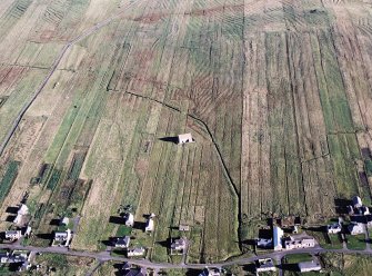 Oblique aerial view centred on the chapel with the township and lazy beds adjacent, taken from the SW.