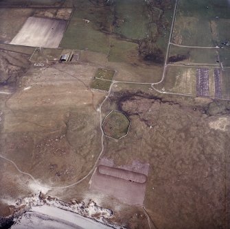 Oblique aerial view centred on the site of the chapel and burial ground with the burial ground adjacent, taken from the NW.