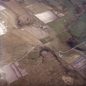 Oblique aerial view centred on the site of the chapel and burial ground with the burial ground adjacent, taken from the WSW.