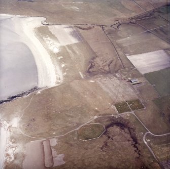 Oblique aerial view centred on the site of the chapel and burial ground with the burial ground adjacent, taken from the SW.