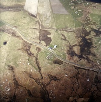 Oblique aerial view centred on the farmstead and the remains of the buildings, taken from the SSE.