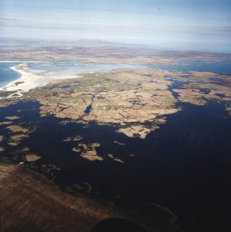 General oblique aerial view over Eochar and Balgarva, looking across Bagh Nam Faoilean and Benbecula, with Ronay and Eaval in the distance, taken from the SW.