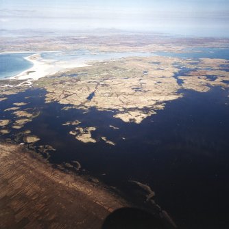 General oblique aerial view over Eochar and Balgarva, looking across Bagh Nam Faoilean and Benbecula, with Ronay and Eaval in the distance, taken from the WSW.