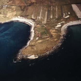 Oblique aerial view centred on the burial grounds and site of the possible chapel, taken from the W.