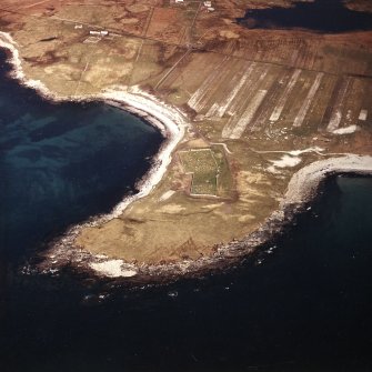 Oblique aerial view centred on the burial grounds and site of the possible chapel, taken from the WSW.