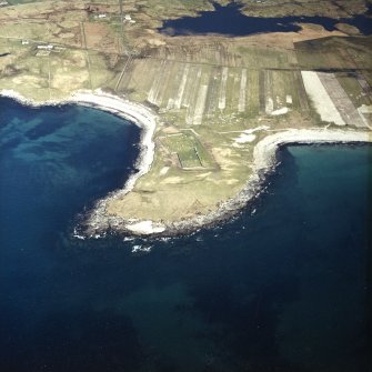 Oblique aerial view centred on the burial grounds and site of the possible chapel, taken from the WSW.