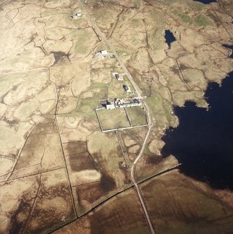 Oblique aerial view centred on the farmsteading and the farmhouse, taken from the WNW.