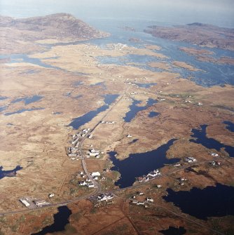 General oblique aerial view looking over the remains of the township, towards Lochboisdale and The Minch beyond, taken from the W.