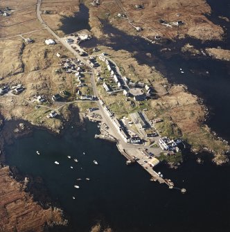 Oblique aerial view centred on the village, with the pier, the school, the church and the hotel adjacent, taken from the SSE.