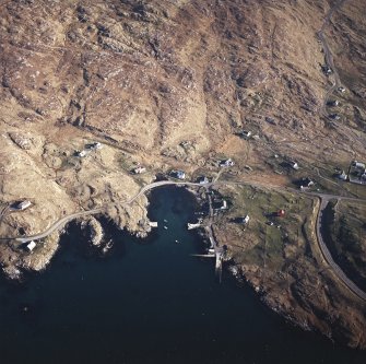 Oblique aerial view centred on the harbour, with the post office adjacent adjacent, taken from the NW.