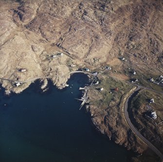 Oblique aerial view centred on the harbour, with the post office adjacent adjacent, taken from the NW.