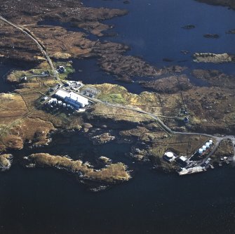 Oblique aerial view centred on the power station, with the jetty and township adjacent, taken from the NE.