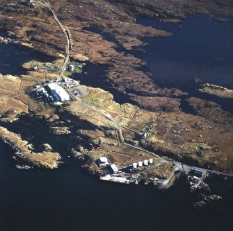 Oblique aerial view centred on the power station, with the jetty and township adjacent, taken from the N.