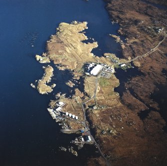 Oblique aerial view centred on the power station, with the jetty and township adjacent, taken from the NW.