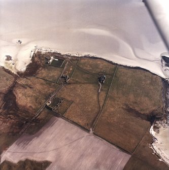 Oblique aerial view centred on the country house and the remains of the house, farmstead and walled garden, taken from the NW.