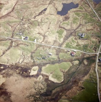 Oblique aerial view centred on the crofting township and the remains of the buildings, taken from the W.