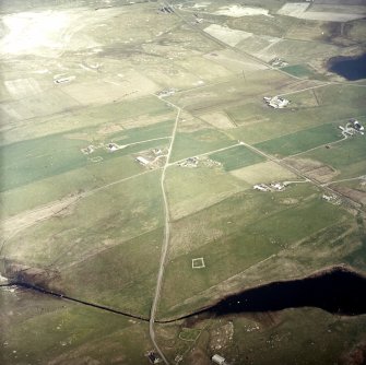 Oblique aerial view centred on the crofting township and remains of the buildings, taken from the WSW.