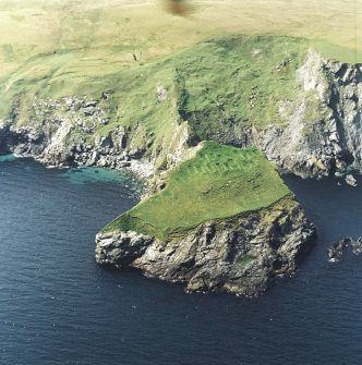 Oblique aerial view centred on the remains of the monastic settlement, taken from the ENE.