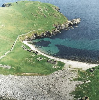 Oblique aerial view centred on the remains of the fishing station and prehistoric house, taken from the NW.