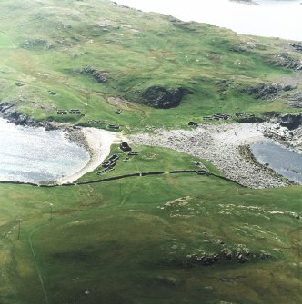 Oblique aerial view centred on the remains of the fishing station and prehistoric house, taken from the NE.