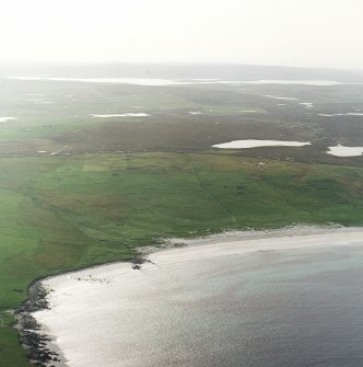 General oblique aerial view centred on the remains of the township, head-dyke and Viking settlement, taken from the ENE.