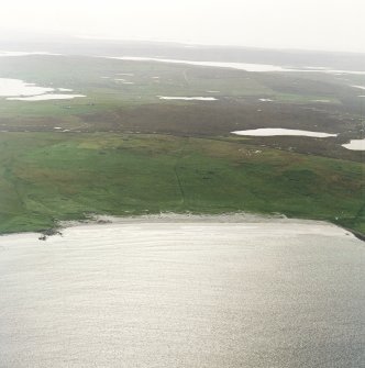 General oblique aerial view centred on the remains of the township, head-dyke and Viking settlement, taken from the NE.